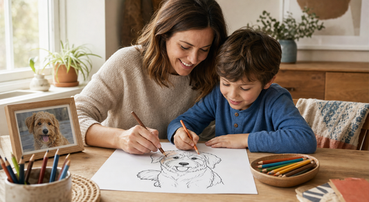 Parent and child coloring a dog outline at a sunny craft table beside a framed photo of the dog