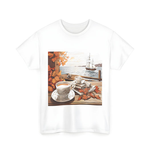 Unisex T-shirt featuring an autumn scene of a tea set on a wooden porch with orange leaves and a sailing ship at sunset. Similar to Tea by the Sea designs, this shirt showcases a serene and idyllic scene perfect for any season.