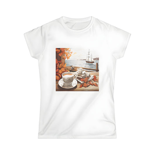 Women's tee featuring an autumnal design of a tea set on a wooden porch with sailing ship at sunset