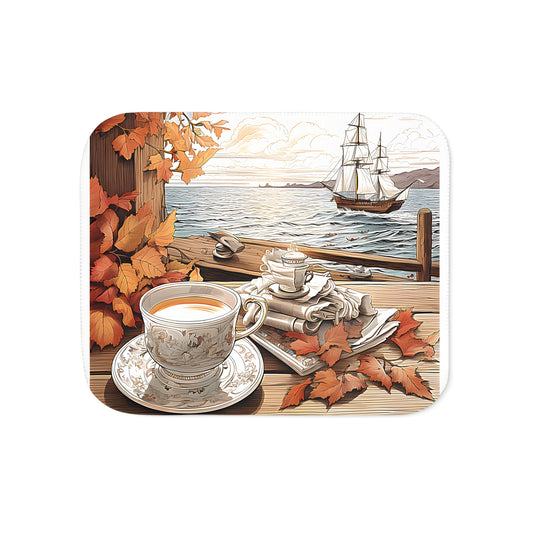 Cozy up with our Tea by the Sea inspired blanket, featuring an autumn scene of a tea set on a wooden porch, surrounded by vibrant orange leaves and a majestic sailing ship at sunset.