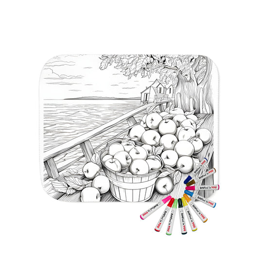 Blanket coloring kit with autumnal fabric markers, featuring a black and white illustration of apples in a bucket on a dock by a tree, with a house and lake in the background.