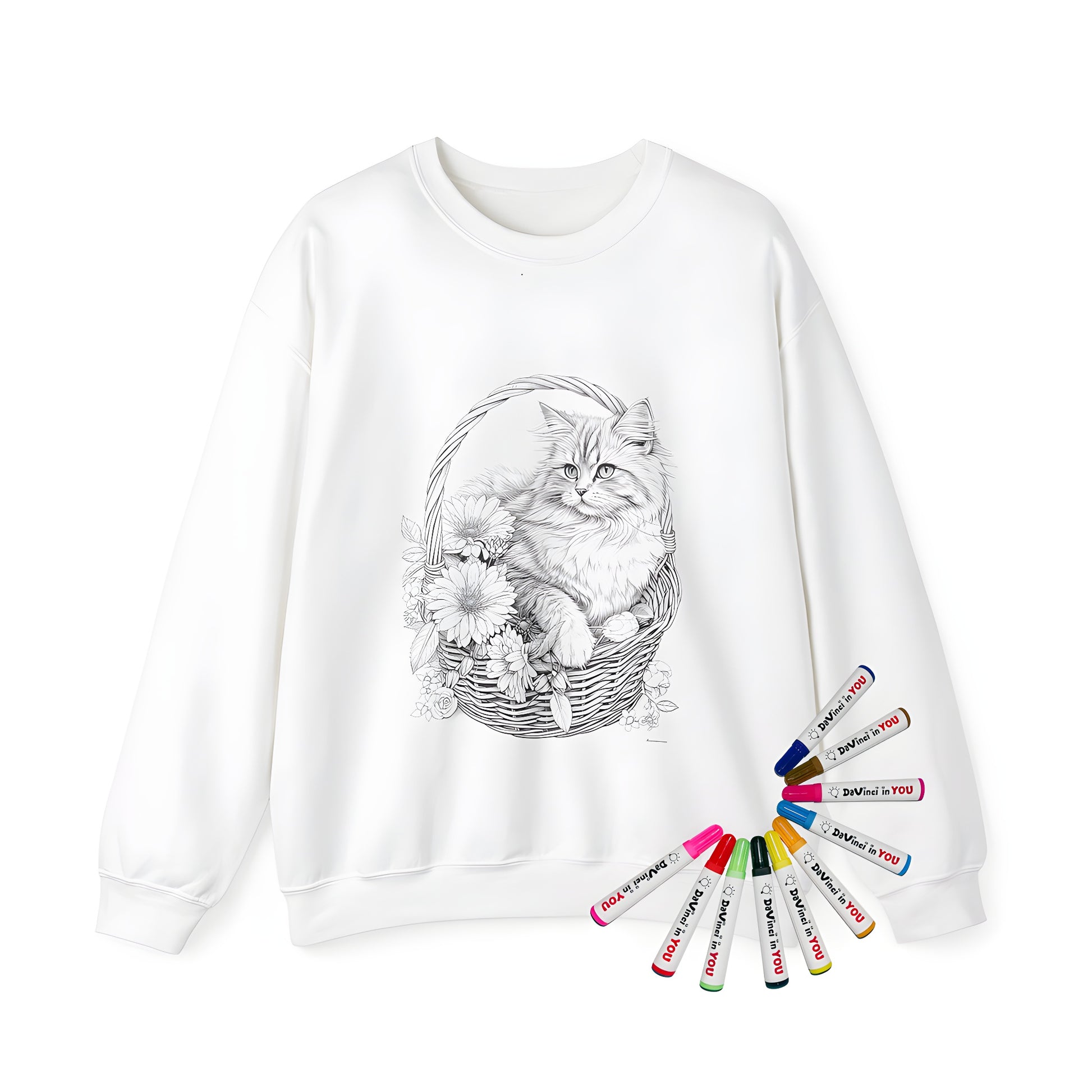 Coloring kit for an adult sweatshirt featuring a detailed black and white sketch of a cat sitting comfortably in a wicker basket surrounded by flowers. Includes 10 fabric markers for easy customisation.