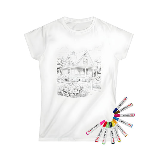 Women's t-shirt featuring a colorful cottage scene with gardens, trees, and fluffy clouds