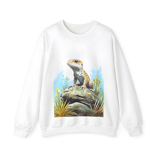 Colorful adult sweatshirt featuring a vibrant gecko perched on a rock amidst yellow flowers and greenery in a natural outdoor setting. Perfect for lizard enthusiasts, gecko fans, and anyone who loves unique reptile-inspired apparel.