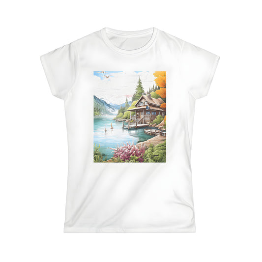 Women's T-shirt featuring a scenic illustration of a cabin surrounded by trees and mountains