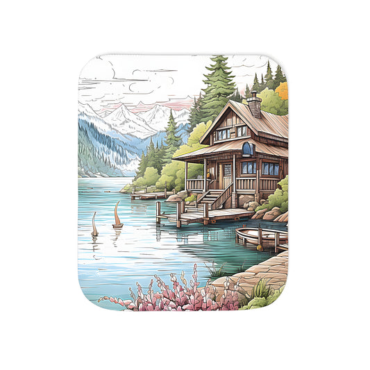 Colorful scenic blanket featuring a lakeside cabin, mountain landscape, and birds