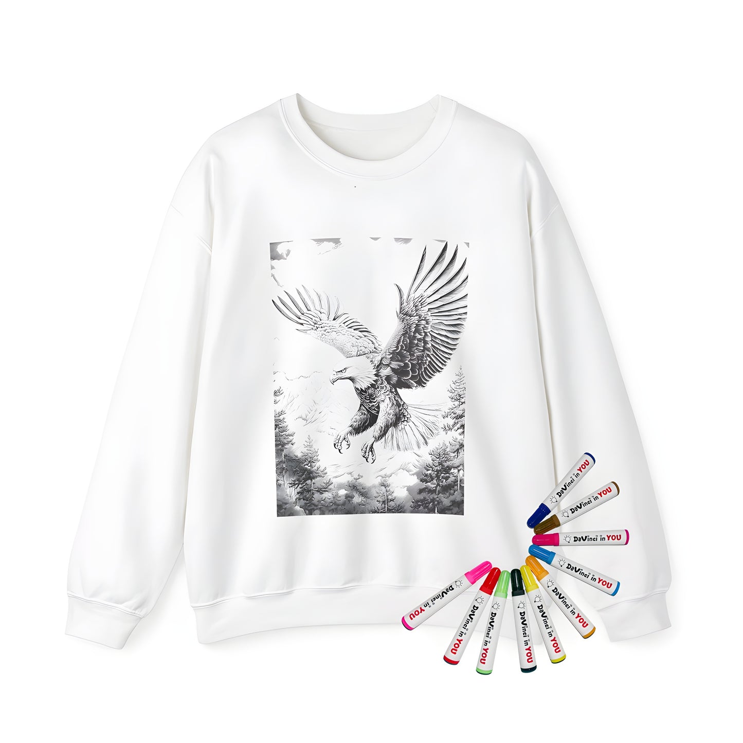 Adult sweatshirt featuring a detailed black-and-white drawing of an eagle with outstretched wings flying over mountains and trees. Plus, included are 10 vibrant fabric markers for endless coloring fun!