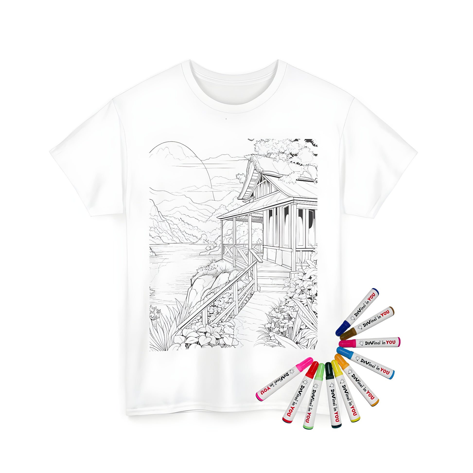 A serene scene of a wooden house near a tranquil lake, surrounded by mountains and lush greenery, printed on a high-quality Unisex T-shirt with vibrant fabric markers