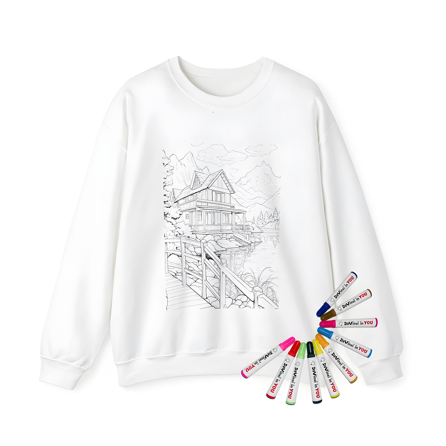 Adult sweatshirt featuring a serene lakeside cabin scene with a wooden bridge, trees, and mountains