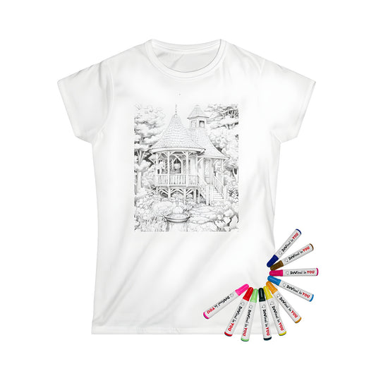 Women's t-shirt featuring a detailed black and white drawing of a wooden cottage with steps, surrounded by trees and foliage, and a fountain in the foreground. Perfect for fans of country homes, rural escapes, or whimsical village scenes.