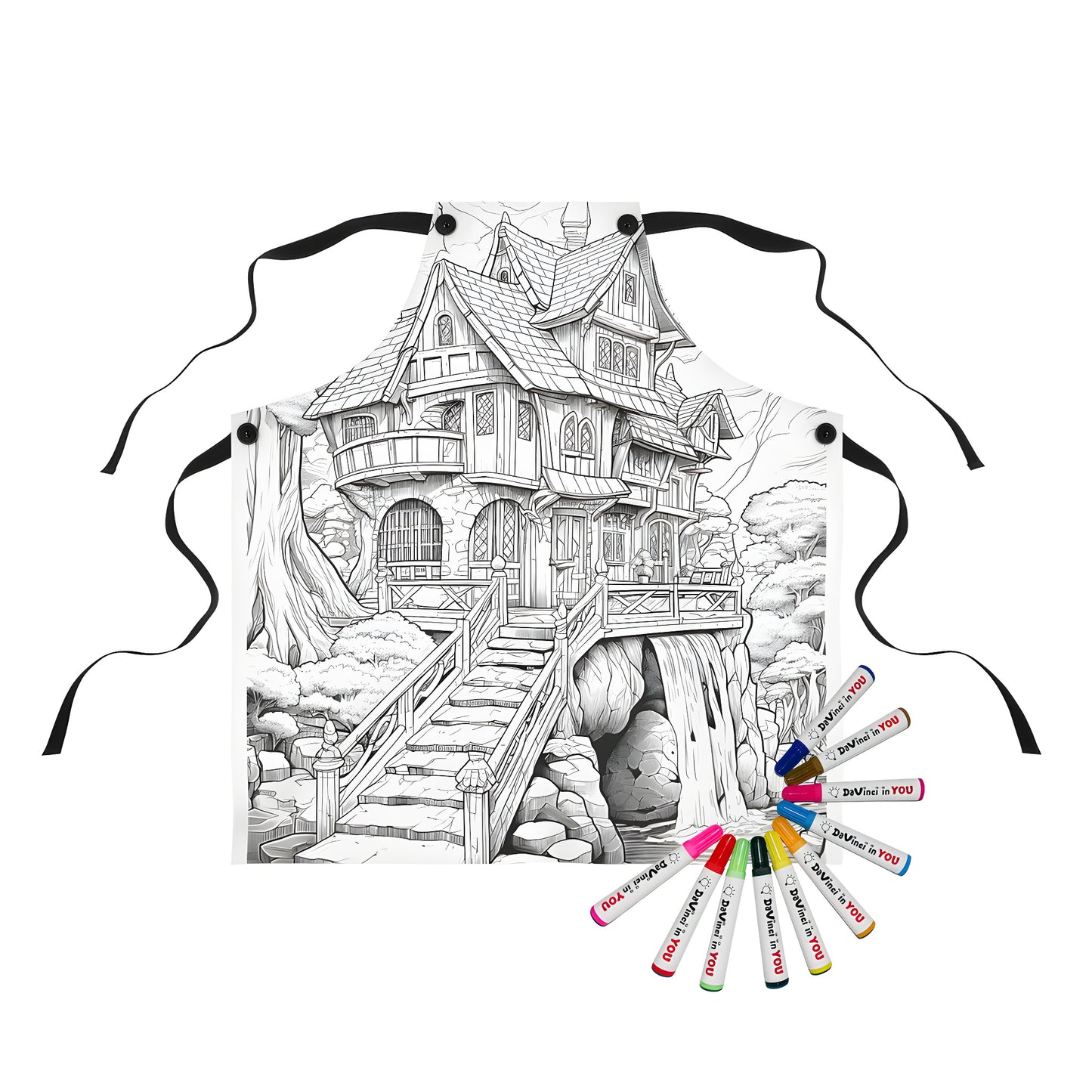 Coloring apron featuring whimsical black and white illustration of fairy tale house with waterfall, stairs, and trees