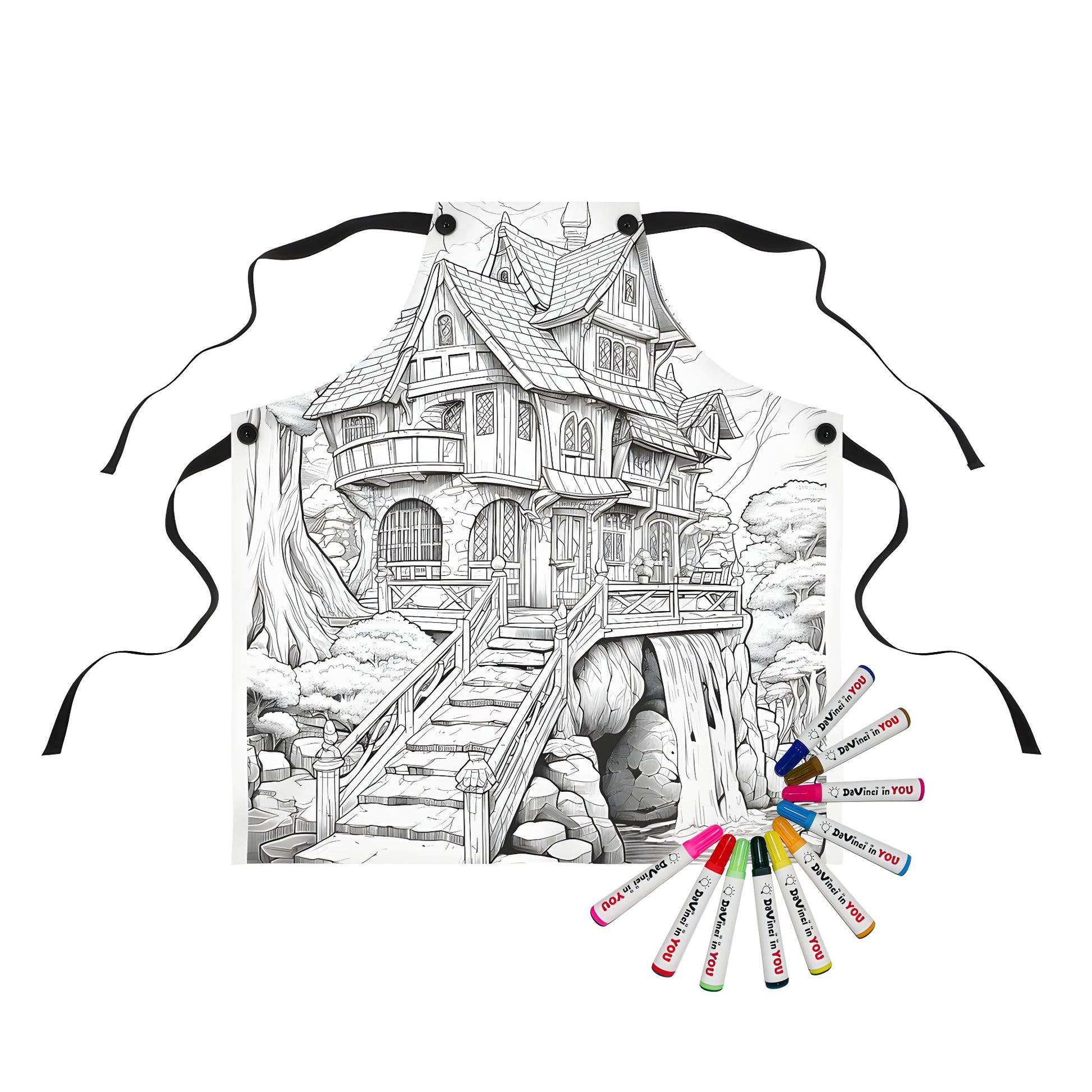 Coloring apron featuring whimsical black and white illustration of fairy tale house with waterfall, stairs, and trees