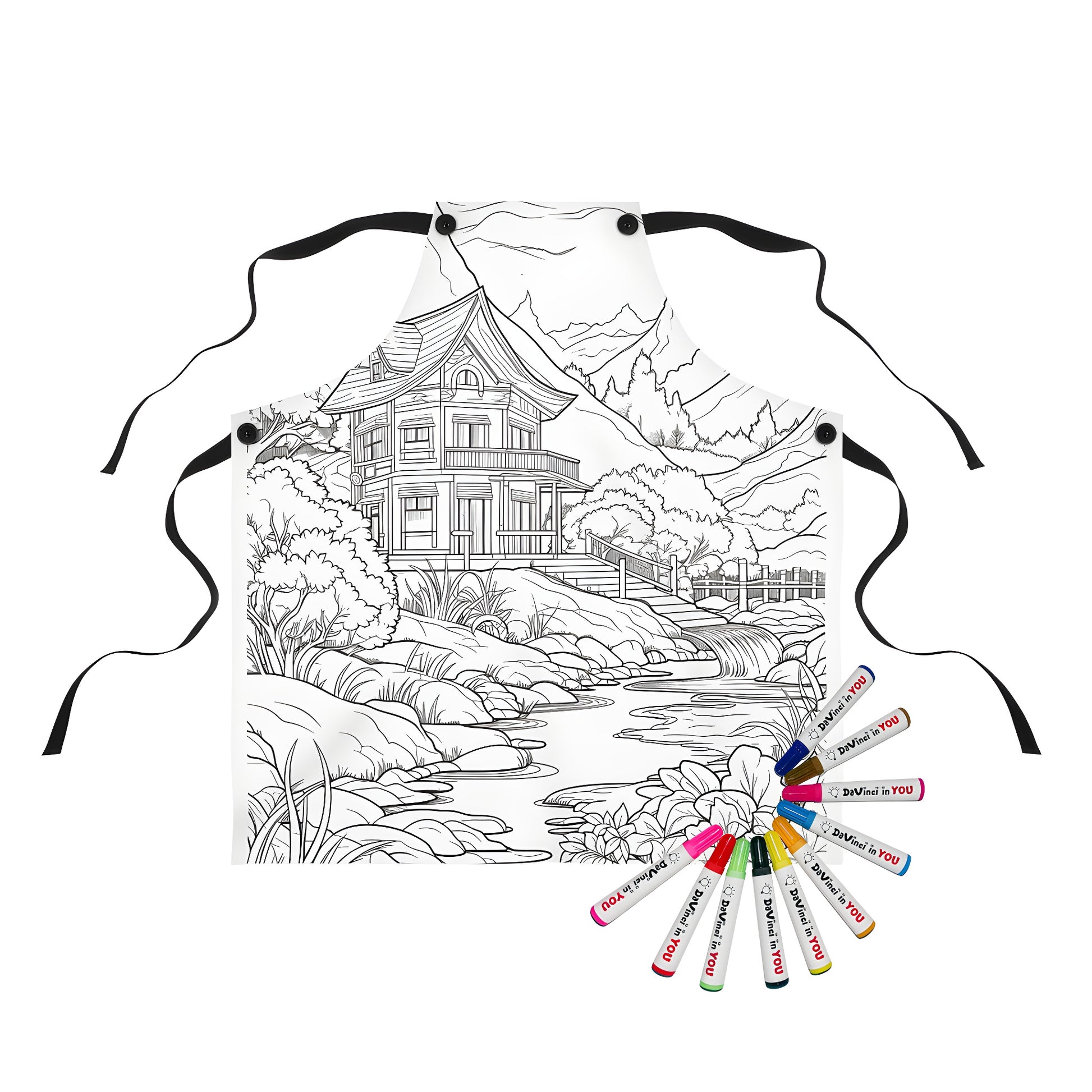 Coloring apron featuring an illustration of a cozy cabin by a stream surrounded by lush trees and mountainous landscape