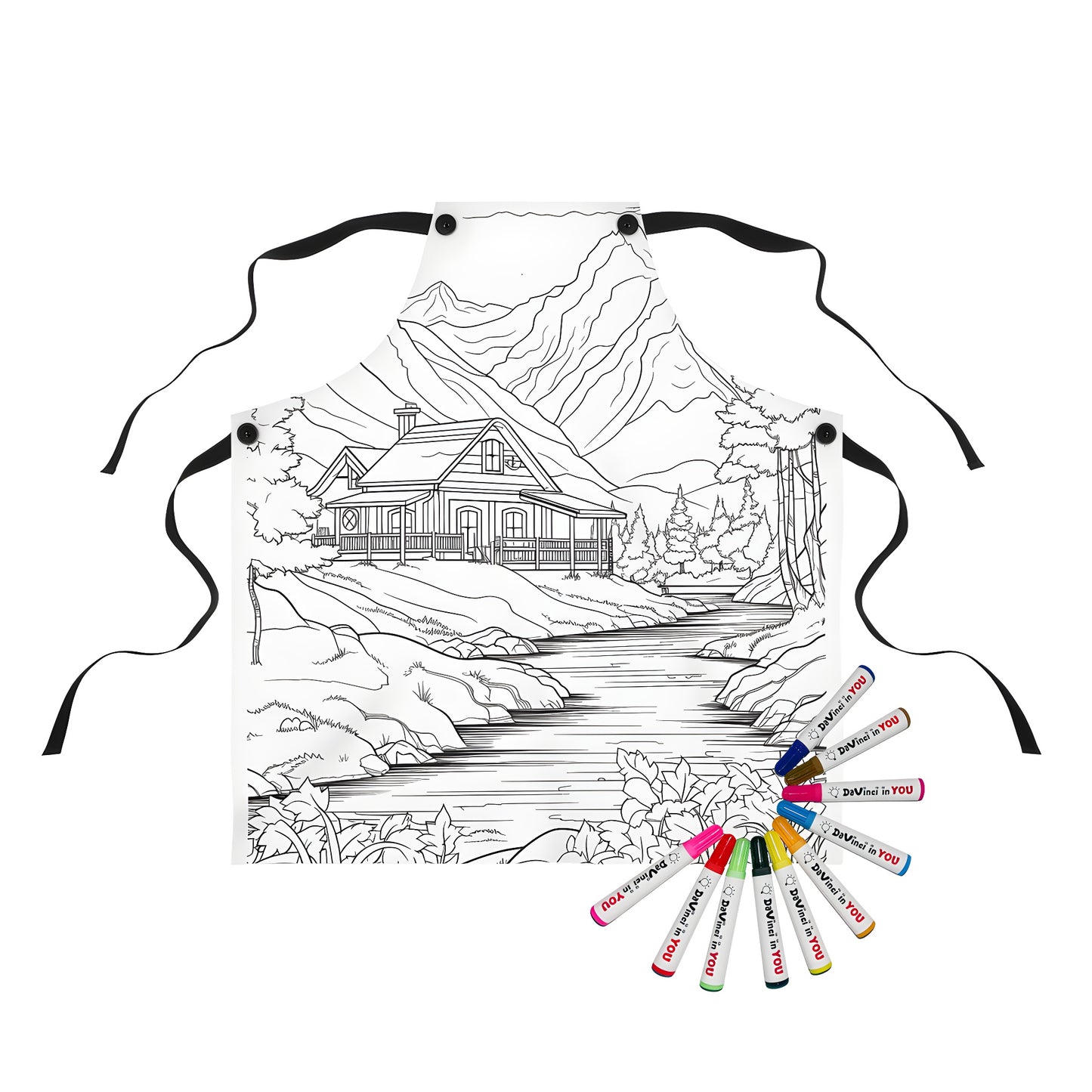 Apron featuring a detailed black and white illustration of a mountain lodge next to a river with trees and mountains in the background, designed for a coloring page experience with 10 fabric markers