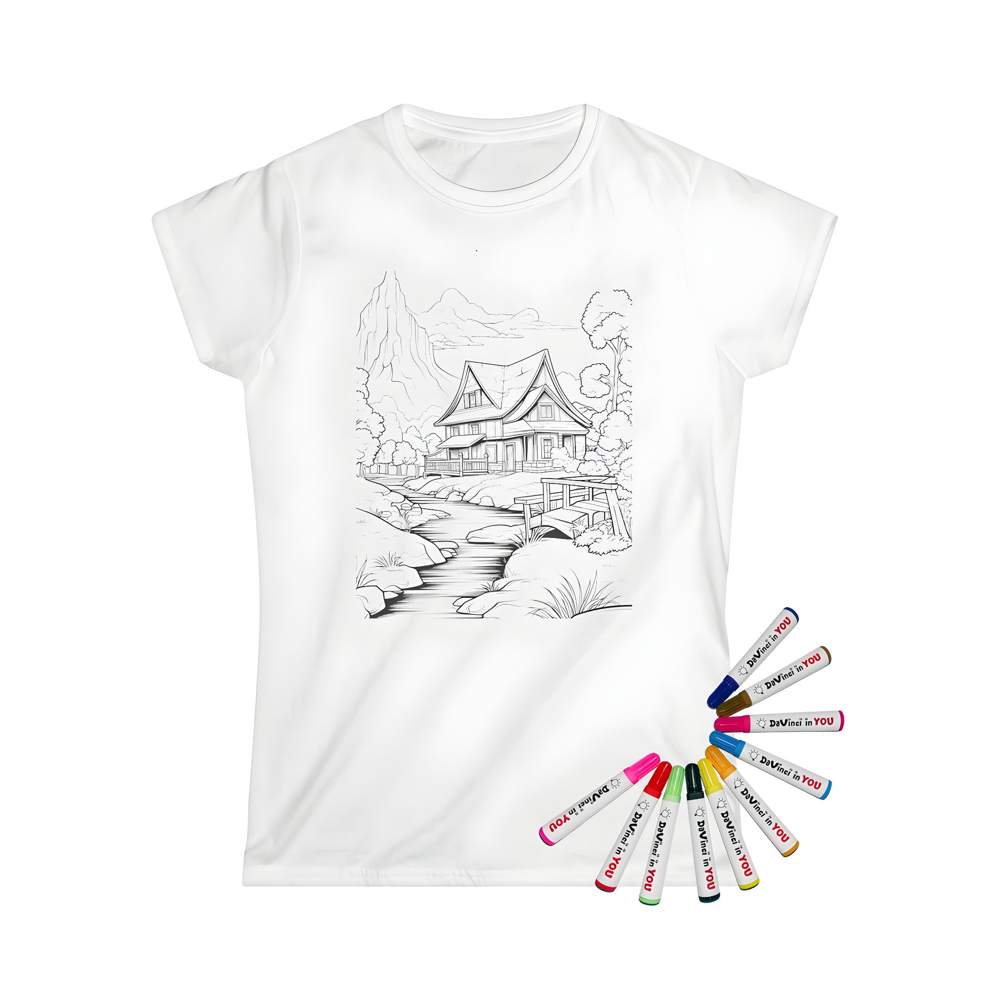 Women's countryside house graphic t-shirt featuring a detailed coloring page design with a stream, wooden bridge, and mountains