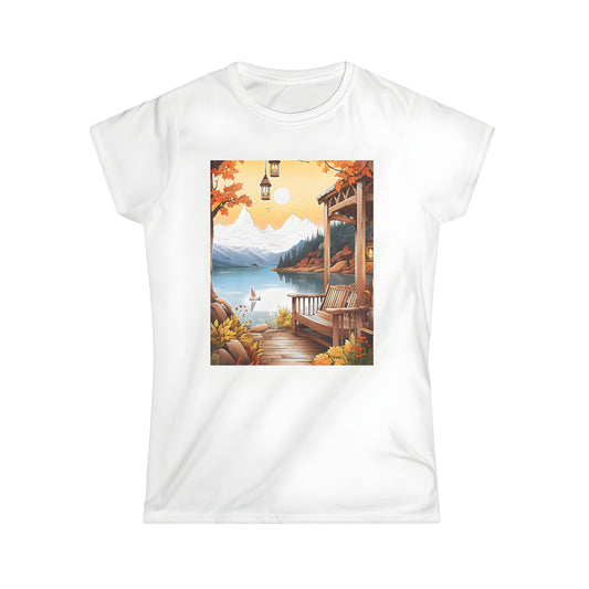 Women's T-shirt with autumn scenic print featuring serene lake, mountains, and cozy wooden deck