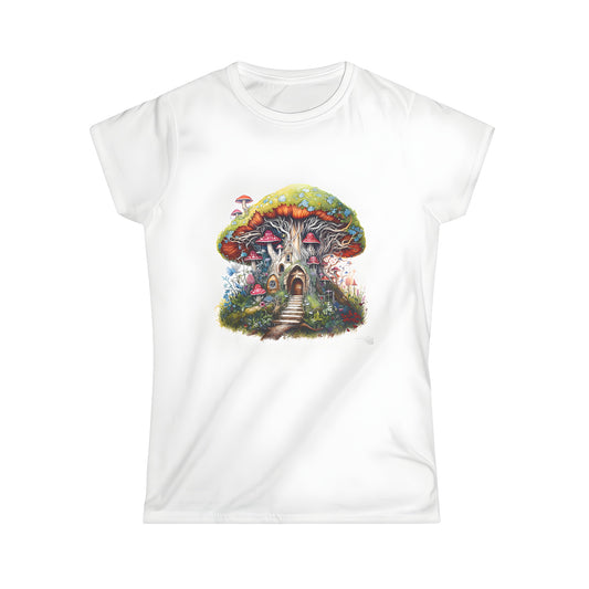 A colorful whimsical mushroom house on a women's t-shirt with a door and windows surrounded by vibrant plants and trees