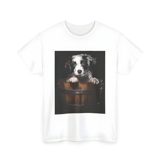 A playful unisex t-shirt featuring an adorable puppy peeking out of a wooden bucket, set against a black background. Perfect for dog lovers and fans of cute animal designs