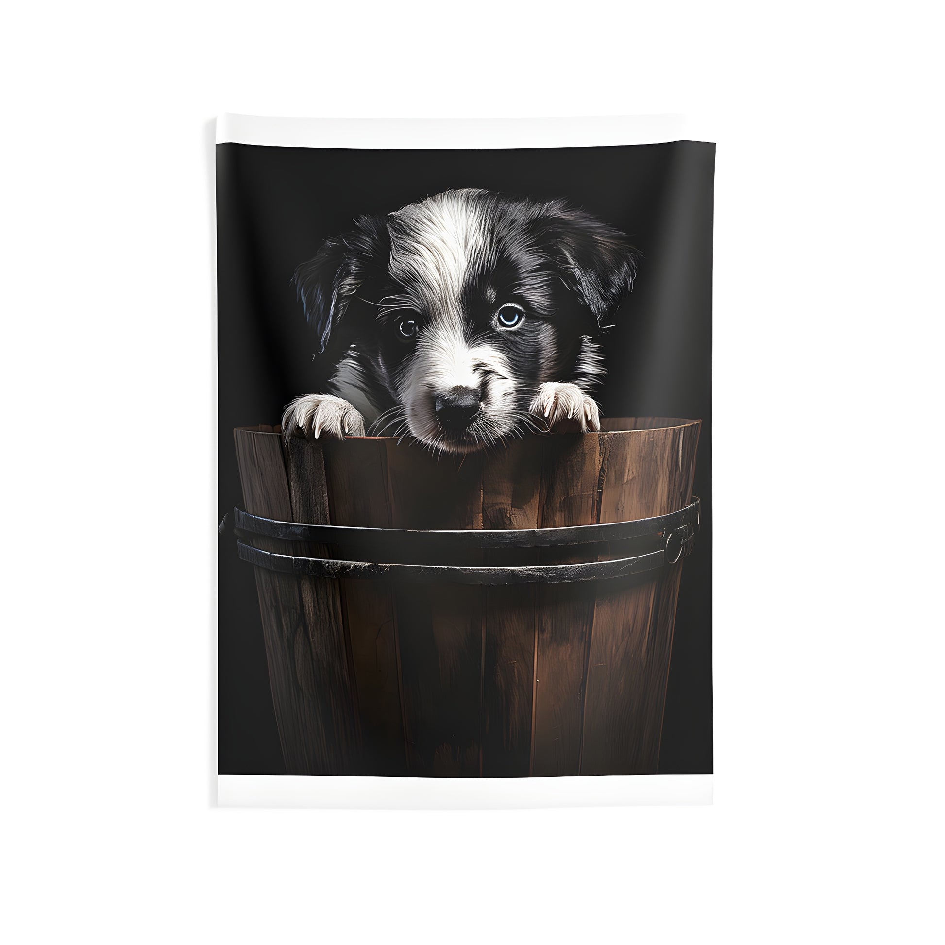 Indoor wall tapestry featuring a playful black and white puppy with blue eyes peeking out from a wooden bucket