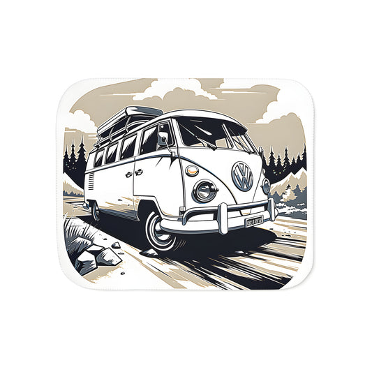 A colorful vintage-style blanket with an illustrated 1950s classic car driving on a forest road surrounded by mountains under a cloudy sky