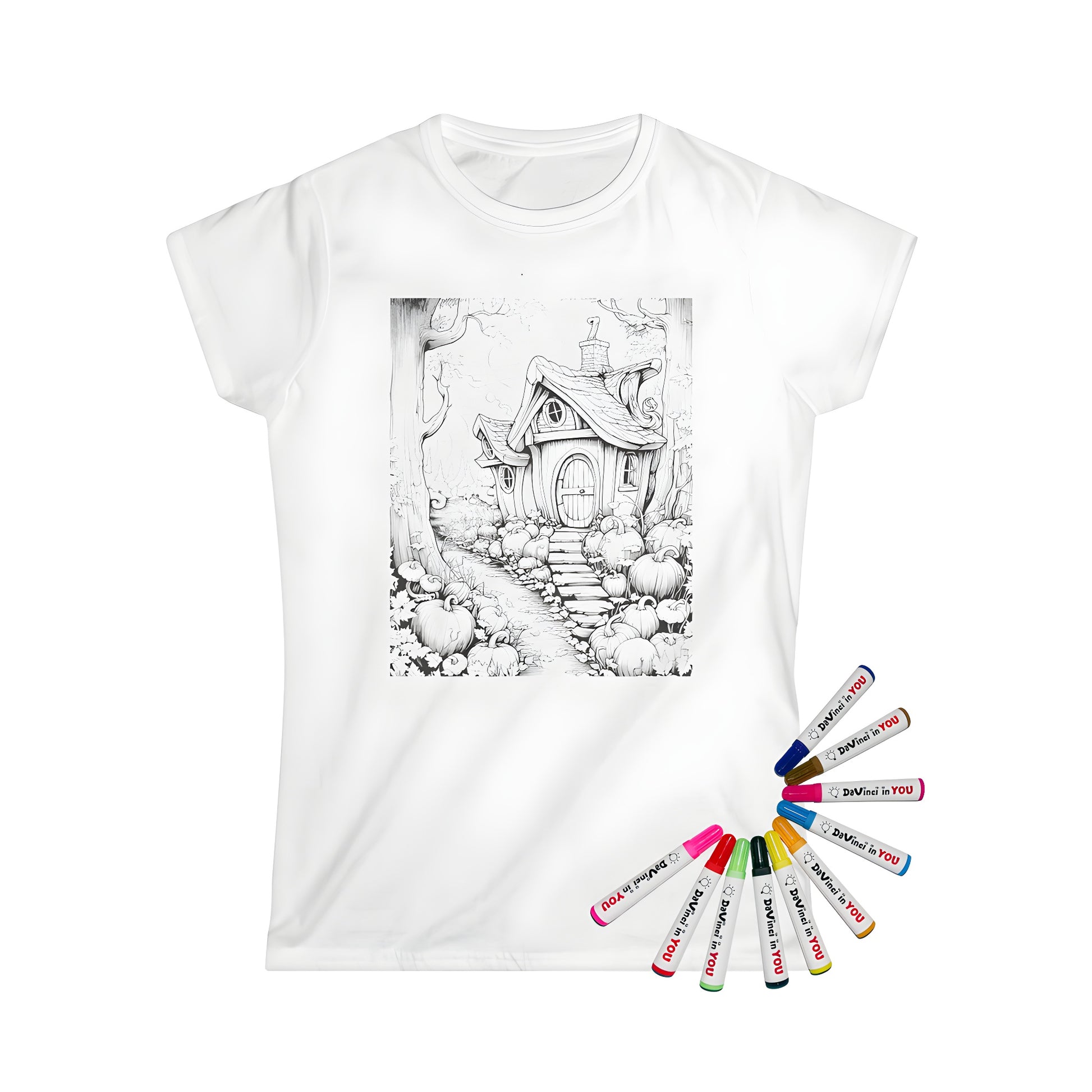 Women's t-shirt featuring a whimsical fantasy cottage illustration surrounded by pumpkins and trees, perfect for coloring with our set of 10 fabric markers.