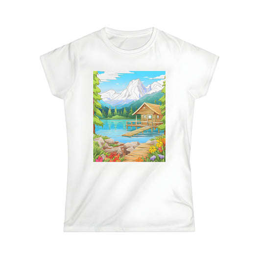 A colorful women's t-shirt featuring a scenic mountain landscape with a wooden cabin by a serene lake, surrounded by vibrant flowers and lush greenery for a relaxed casual look.