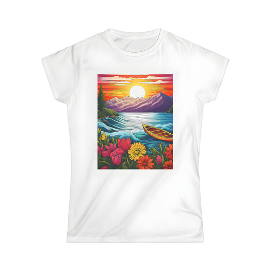 A colorful women's t-shirt featuring a vibrant sunset landscape print with mountains, lake, boat, and blooming flowers in the foreground.