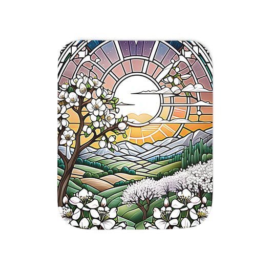 Vibrant blanket featuring colorful designs of flowering trees and blossoms against a stunning sunset backdrop