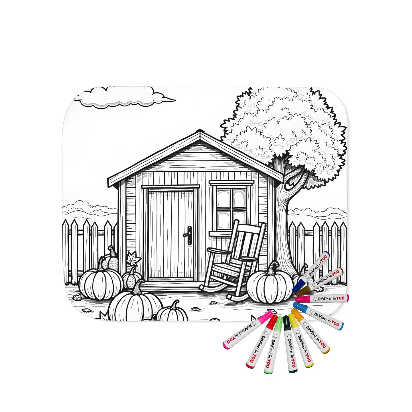 Cozy blanket with autumn-themed coloring page design featuring a quaint cottage, pumpkins, tree, and picket fence