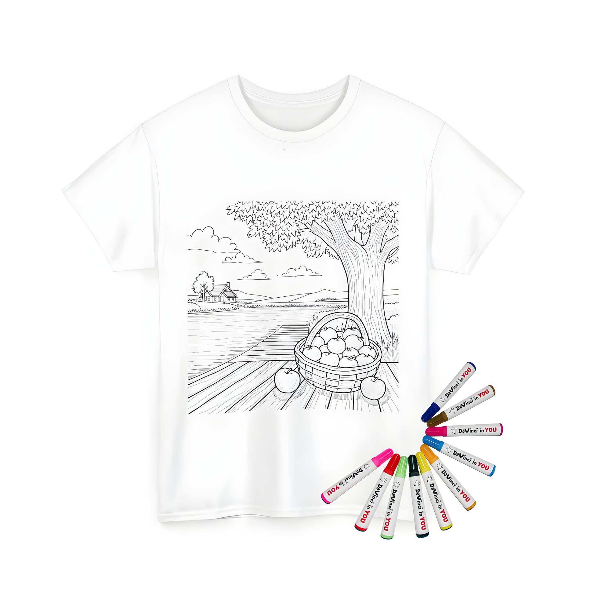 A charming Unisex T-shirt featuring a vibrant coloring page design of a peaceful countryside scene with a basket of apples on a wooden dock, surrounded by a tree and overlooking a serene river landscape.