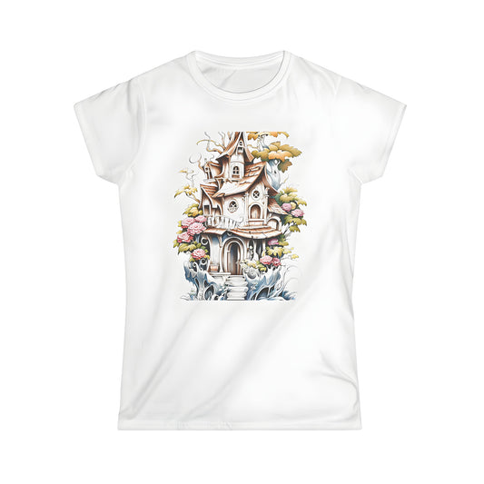 Women's colorful graphic t-shirt featuring whimsical cottage design with curved roofs and intricate details, surrounded by lush flowers and vines