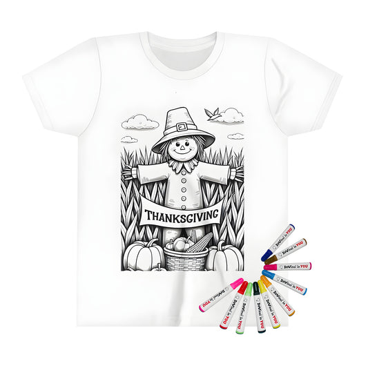 Black and white scarecrow in a field holding a 'Thanksgiving' banner with pumpkins and corn, on kid's t-shirt