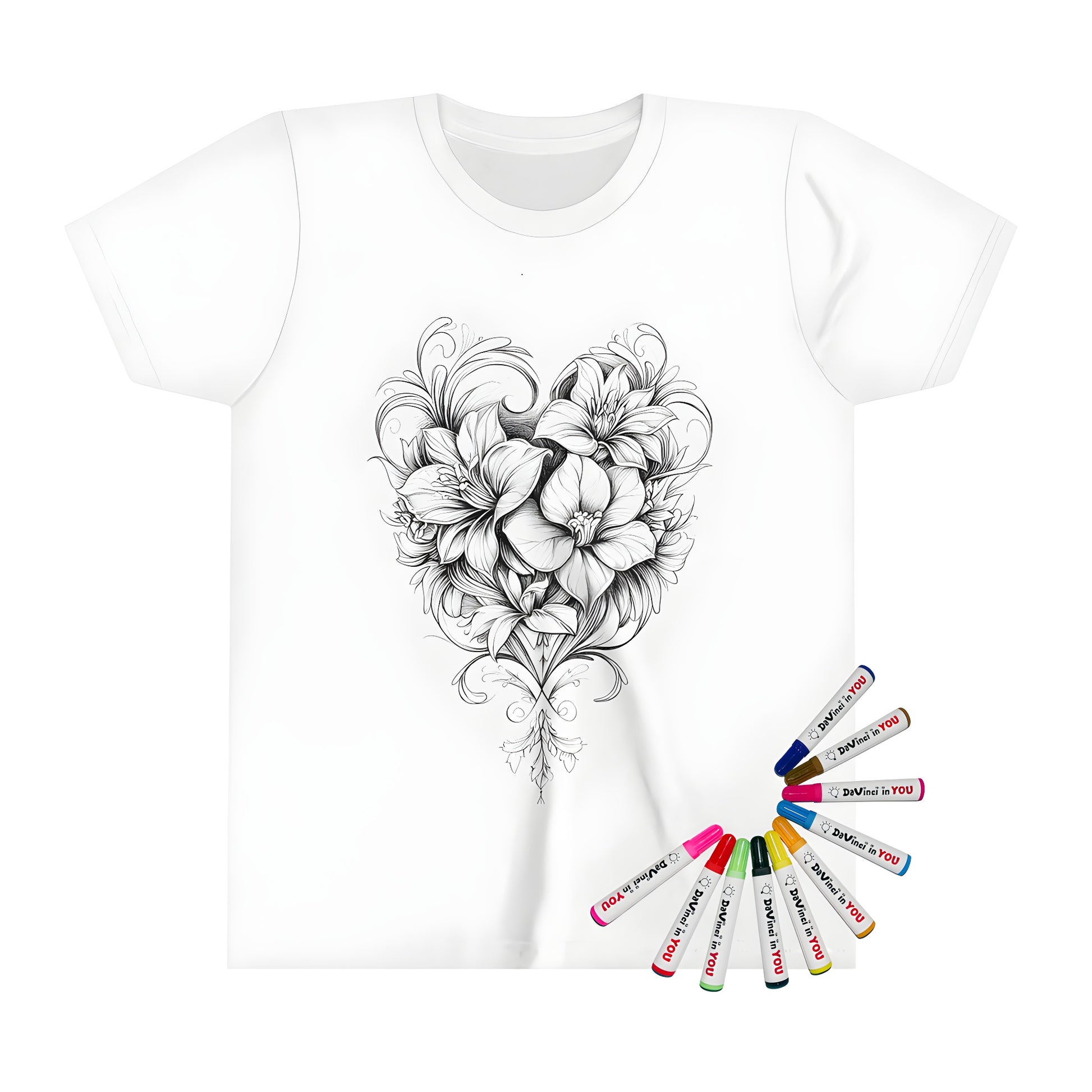 A detailed black and white drawing of intricately arranged flowers in a heart shape on a kids' t-shirt, with colorful fabric markers nearby