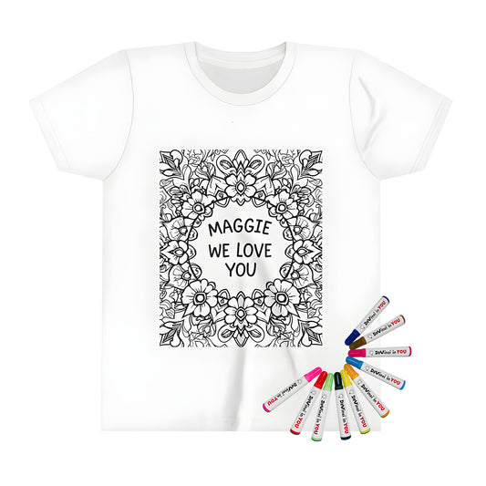 Coloring page inspired kid's t-shirt featuring a floral mandala design with decorative flowers and 'Maggie we love you' in the center