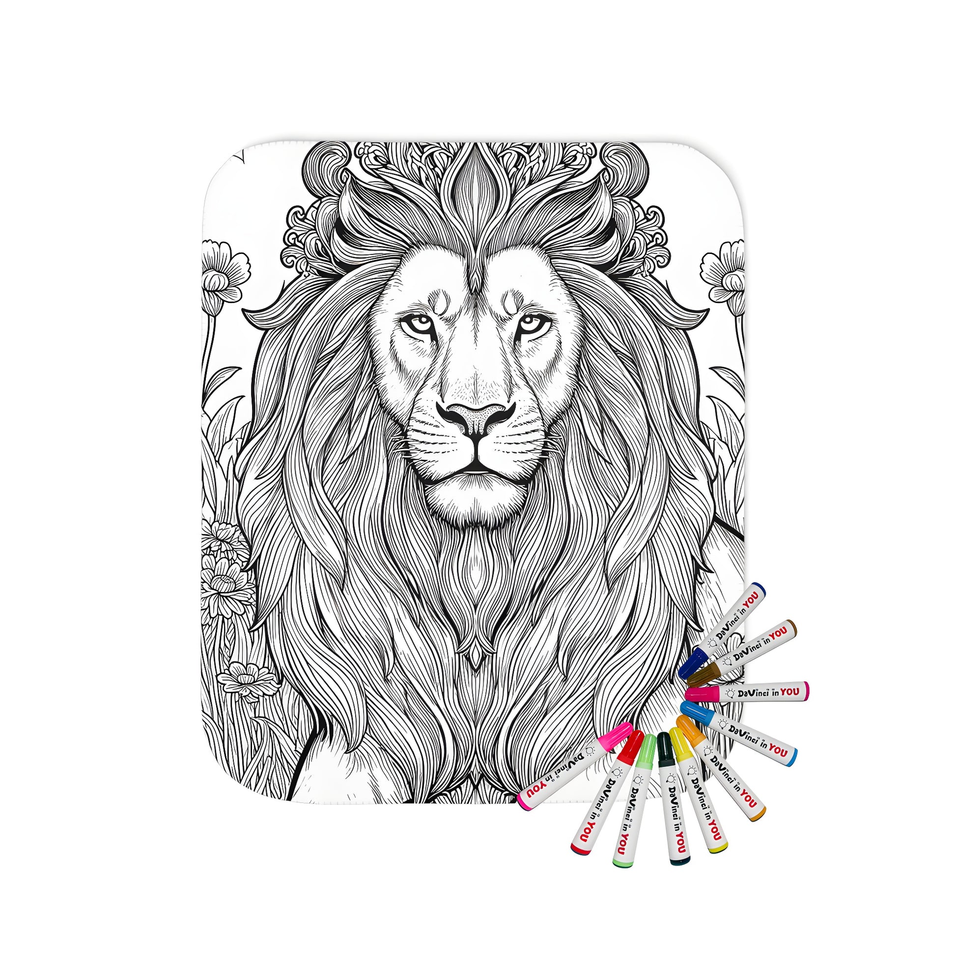 Coloring page featuring an intricate black and white drawing of a regal lion with a decorative mane amidst flowers and grass on a soft blanket