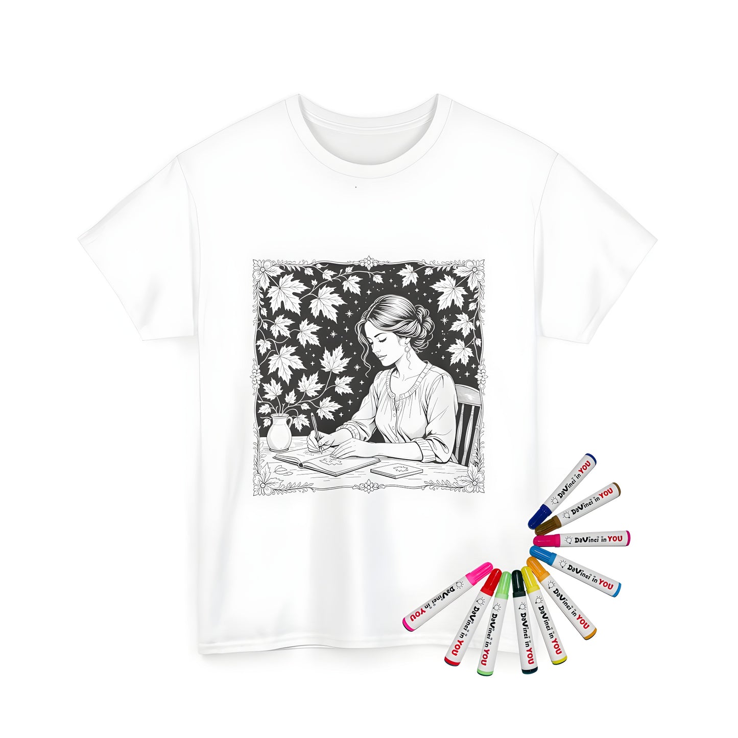 Unisex t-shirt with colorful illustration of woman sitting at a table writing in a book surrounded by leaves and stars