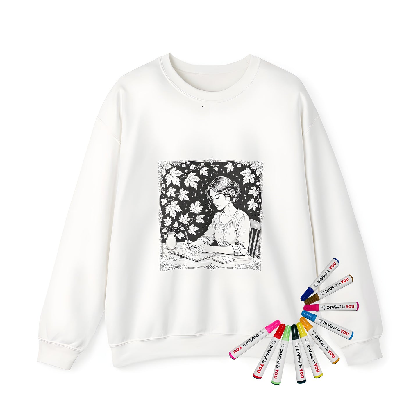Adult sweatshirt with coloring page design of serene woman at desk, writing in book surrounded by leaves and stars