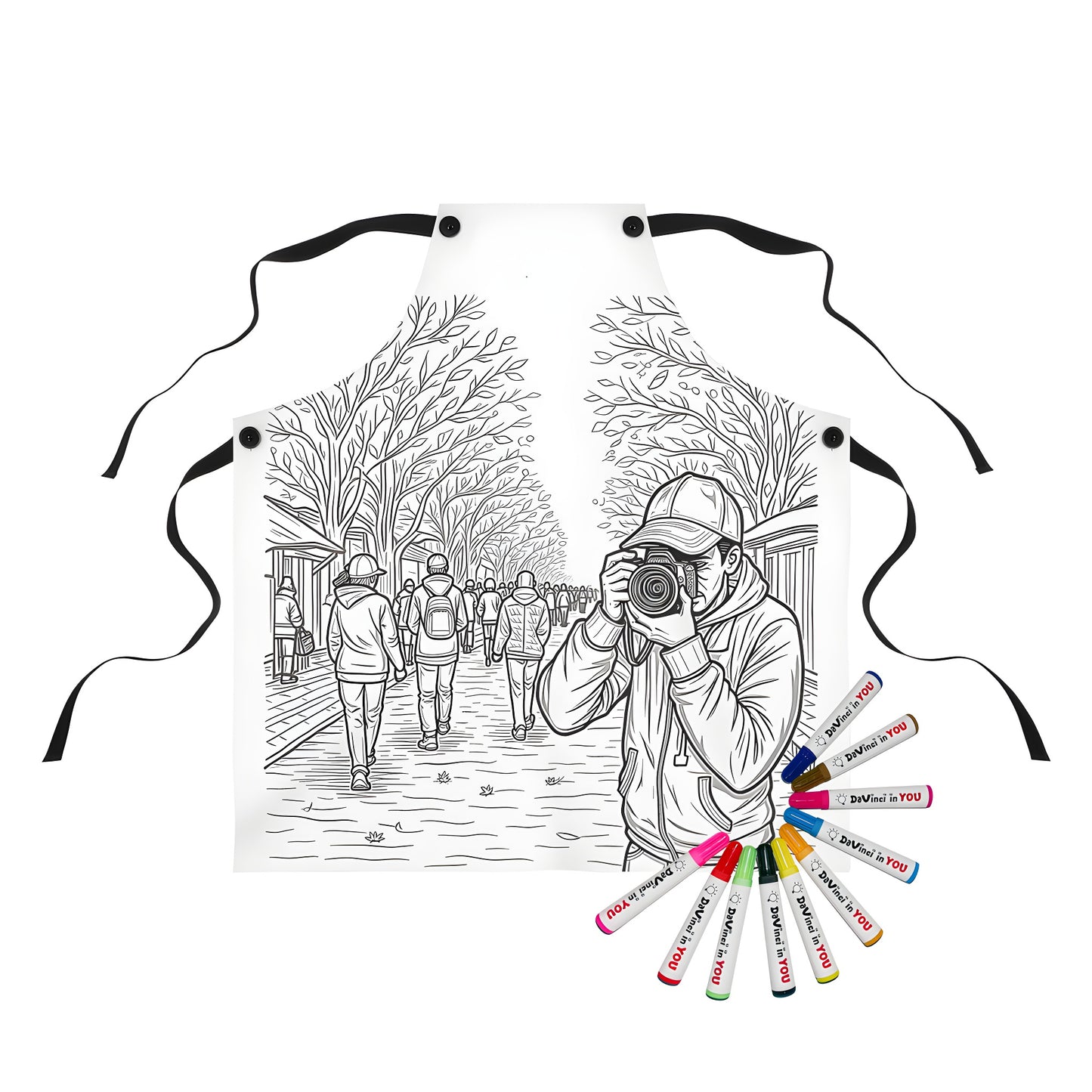 Coloring apron for kids with 10 vibrant fabric markers, featuring a black and white illustration of a photographer or snapper taking a picture on a tree-lined city street bustling with busy people