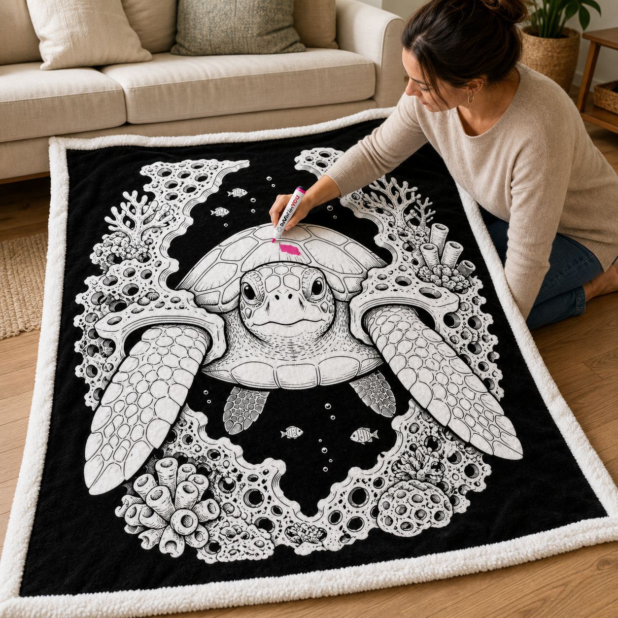 Adult coloring a White color-your-own sherpa blanket with a fabric marker